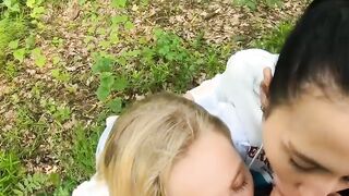 Two Girlfriends Suck Cock in the Wood