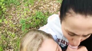 Two Girlfriends Suck Cock in the Wood
