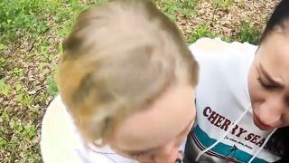 Two Girlfriends Suck Cock in the Wood