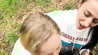 Two Girlfriends Suck Cock in the Wood