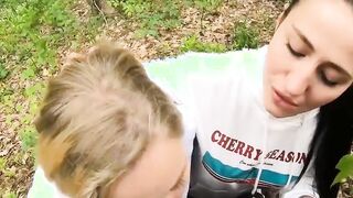 Two Girlfriends Suck Cock in the Wood
