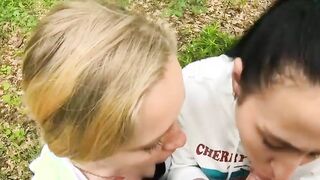 Two Girlfriends Suck Cock in the Wood