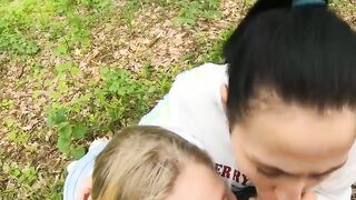Two Girlfriends Suck Cock in the Wood