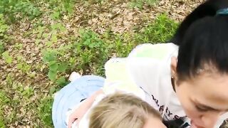 Two Girlfriends Suck Cock in the Wood