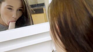 Teen sucking dildo in front of mirror