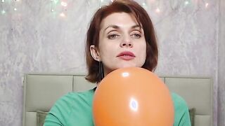 Redhead Milf plays with balloon on webcam