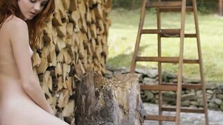 Redhead Russian naked babe chopping wood