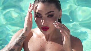 Glamorous naked babe posing by the pool