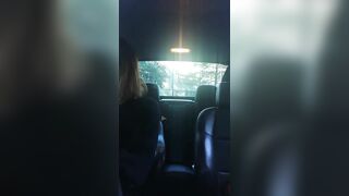 Woman riding the gear shift in her car into outside