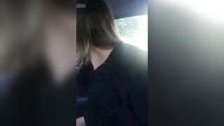 Woman riding the gear shift in her car into outside