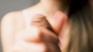 Red-lipped beauty gives an intense handjob to her man