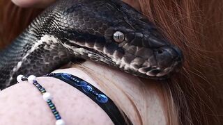 Redhead snake charmer poses nude outdoor