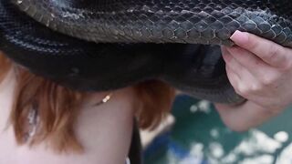 Redhead snake charmer poses nude outdoor