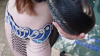 Redhead snake charmer poses nude outdoor