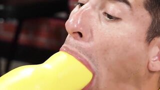 Jockstrapped lad sucks and plays with enormous dildos