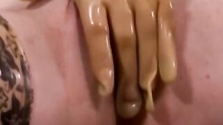 Busty masked babe in full latex suit finger fucks herself