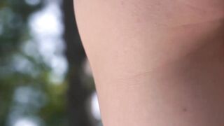 Gorgeous petite woman seductively moving while undressing