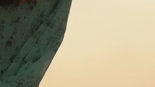Sensual beauty is showing her naked body while on the beach