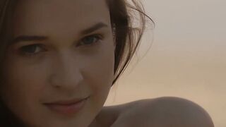 Sensual beauty is showing her naked body while on the beach
