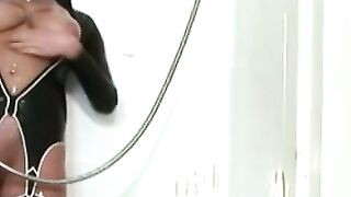 Lesbian in kinky outfit rides dildo in bathroom and showers