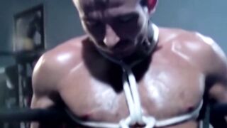 Tattooed wrestler tied up and dominated by his opponent