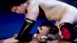 Tattooed wrestler tied up and dominated by his opponent
