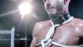 Tattooed wrestler tied up and dominated by his opponent