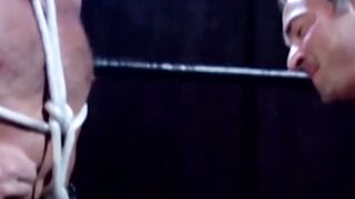 Tattooed wrestler tied up and dominated by his opponent
