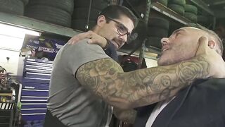 Dominant car mechanic subdues handsome hunk for feet worship