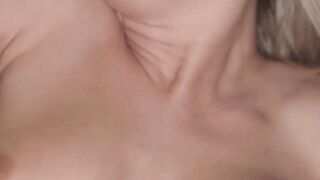 Naughty blonde in black lingerie rubs her pink soft pussy