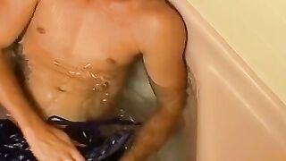 Fully clothed twink Kelly Cooper masturbates in bathtub