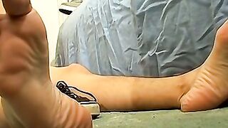 Skinny tattooed twink shows off his feet while masturbating