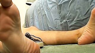 Skinny tattooed twink shows off his feet while masturbating
