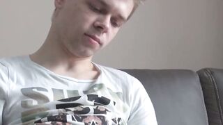 Tattooed twink Axel masturbates solo while watching porn