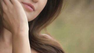 Good looking girl passionately sways her body in a field
