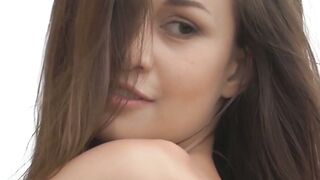 Good looking girl passionately sways her body in a field