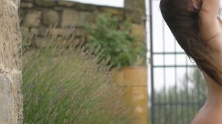 Good looking girl passionately sways her body in a field
