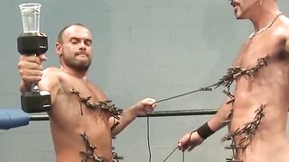 Tattooed muscle hunks torment each other with nipple clips