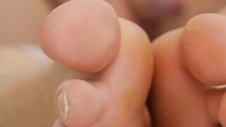 Young blond jock touches his feet while masturbating solo