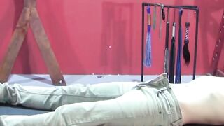 Petite slave restrained for rough BDSM tormenting session