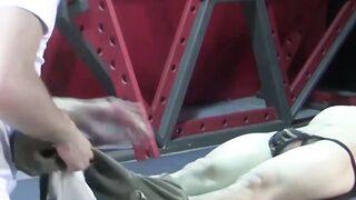 Petite slave restrained for rough BDSM tormenting session