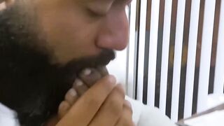 Bearded black stud licks his bosses feet while masturbating
