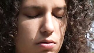 Cutie with curly hair fingers herself solo outside for us