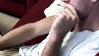 Sexy and cute Jake Parker smoking a cigar and stroking dick