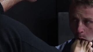 Bearded guard Rikk York receives foot licking from prisoner