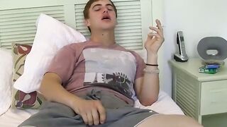Stunning smoker blows smoke rings while he rubs his dick out
