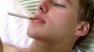 Stunning smoker blows smoke rings while he rubs his dick out