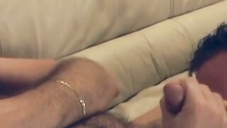 Older man is stroking his shaft as his lover licks his balls