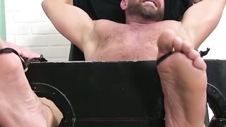 BDSM foot tickling torment with restrained bearded hunk