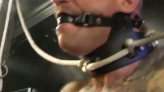 Hunk in bondage gear enjoying domination by his buff partner